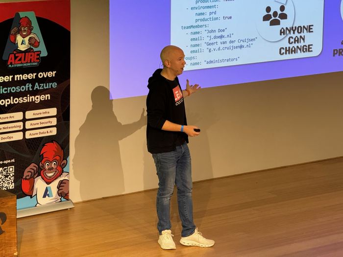A speaker walking through code on the big screen