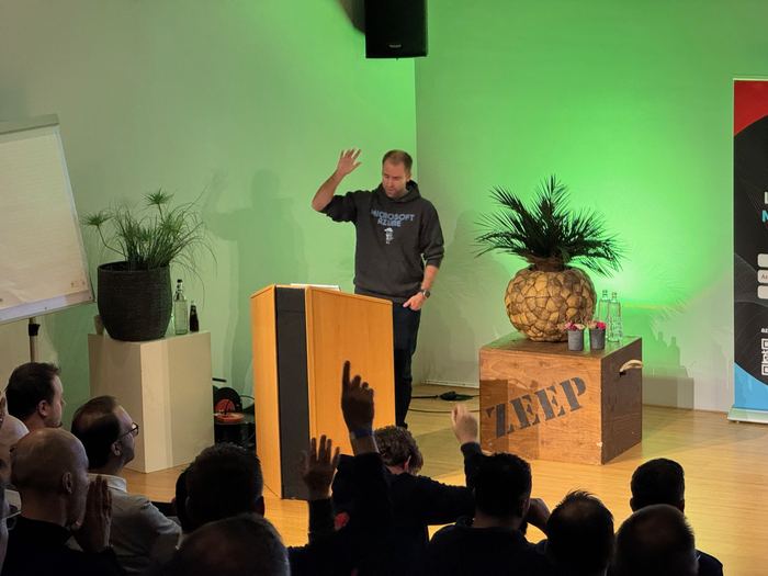 A speaker closing their session in the Auditorium
